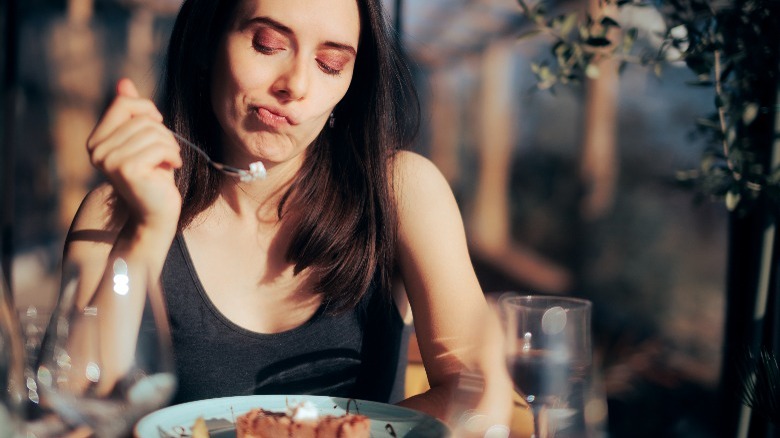 Someone examining her meal