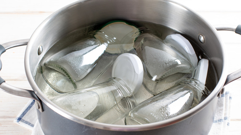 A collection of jars being sterilized