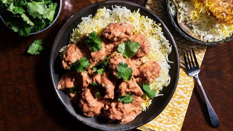 Butter chicken with rice on plate