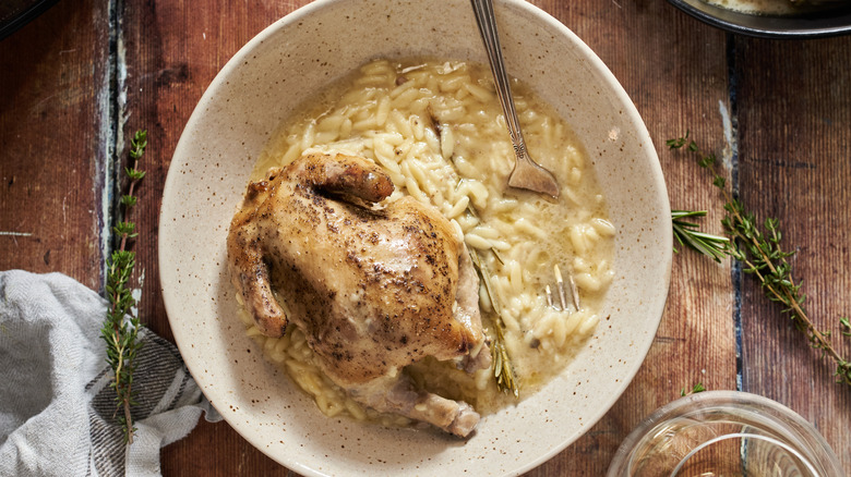 Cornish hen with orzo on table