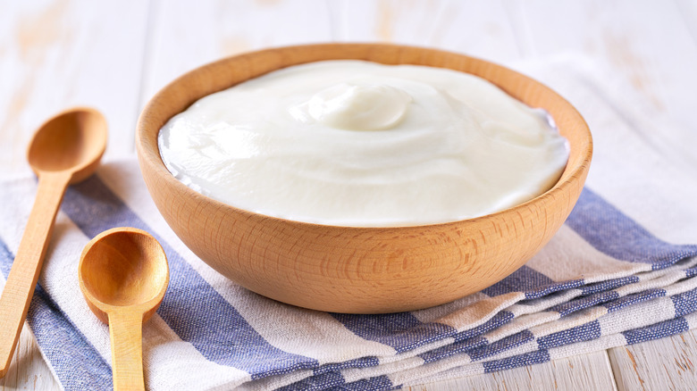 Greek yogurt in wooden bowl