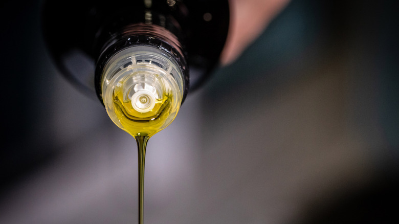 Olive oil being poured from a bottle