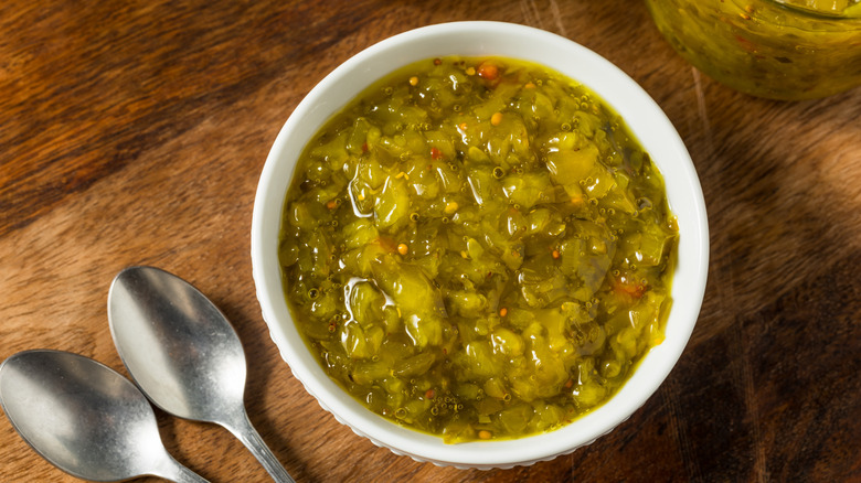 Pickle relish in white bowl on wooden table