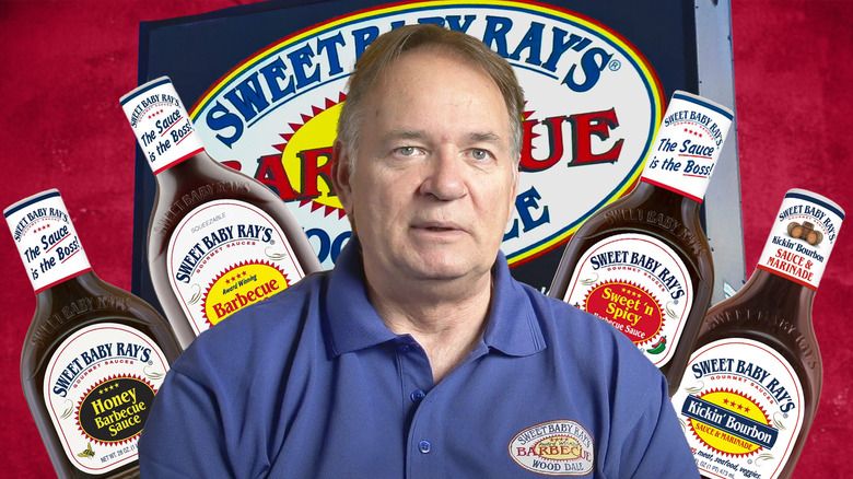 founder of sweet baby ray's dave raymond surrounded by barbecue sauce bottles