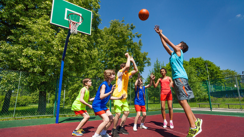 kids playing basketball outdoors