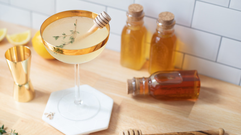 coupe glass and honey bottles