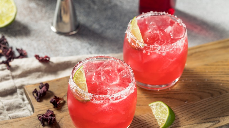 Two hibiscus margaritas and lime