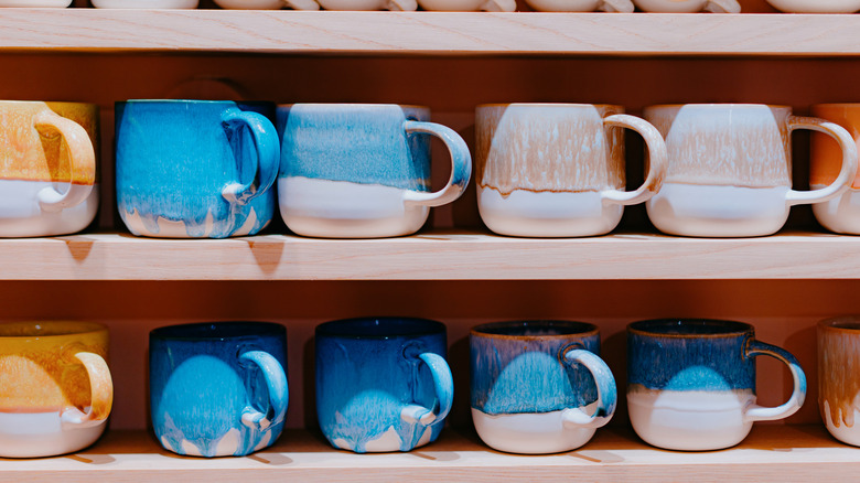 Shelf full of various mugs in bright colors