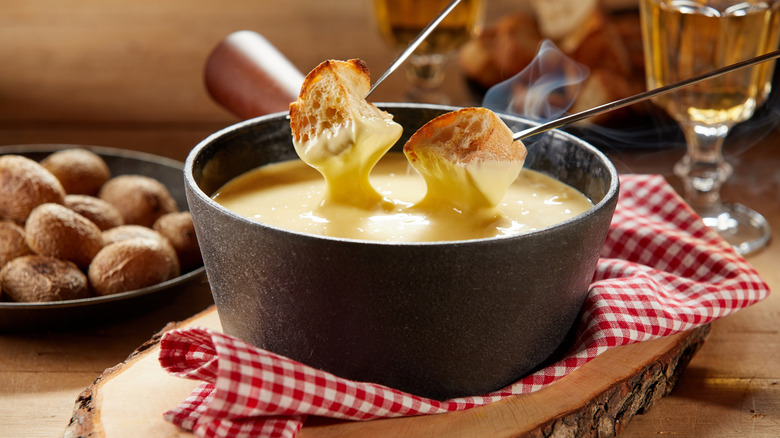 Bread dipping in fondue