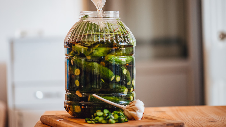 pouring brine over pickles