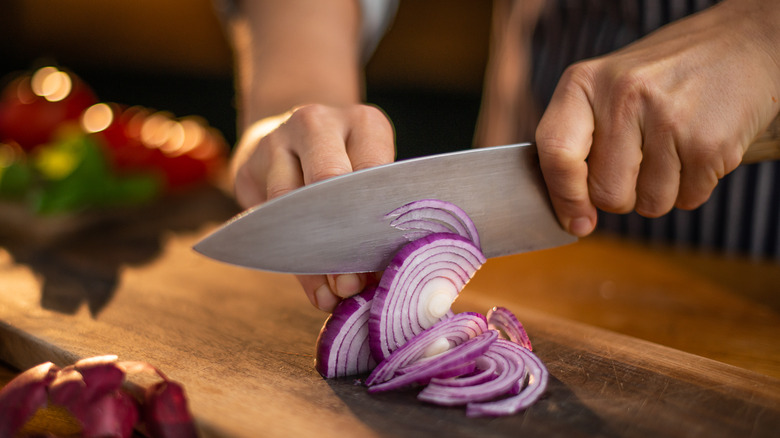 Sharp knife cutting onion