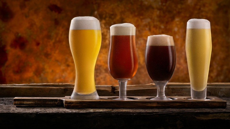 range of different beer glasses containing beer