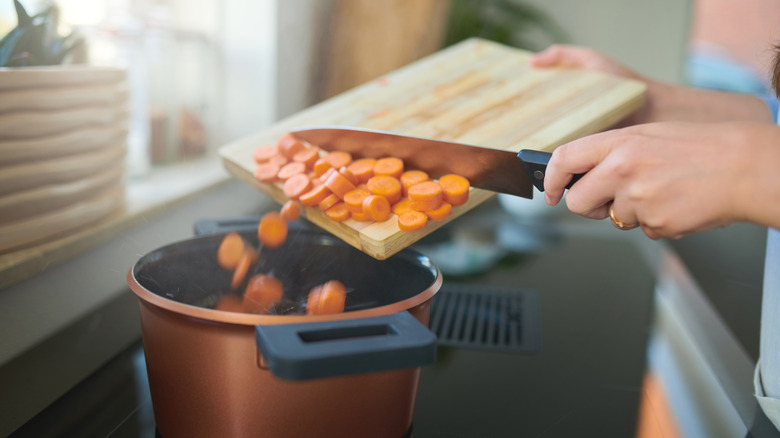 adding carrots to pot