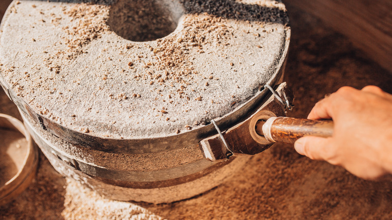 Turing wheat into flour with an antique mill