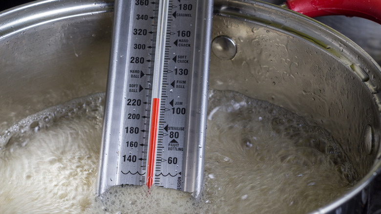 Candy thermometer in boiling sugar.