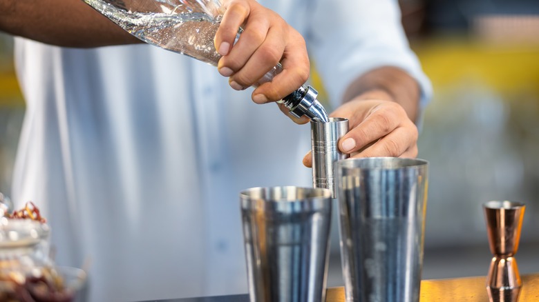 bartender measuring shots of liquid