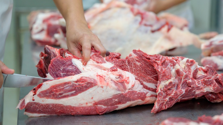  Butcher trimming meat