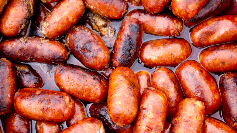 Chorizo sausages frying in oil