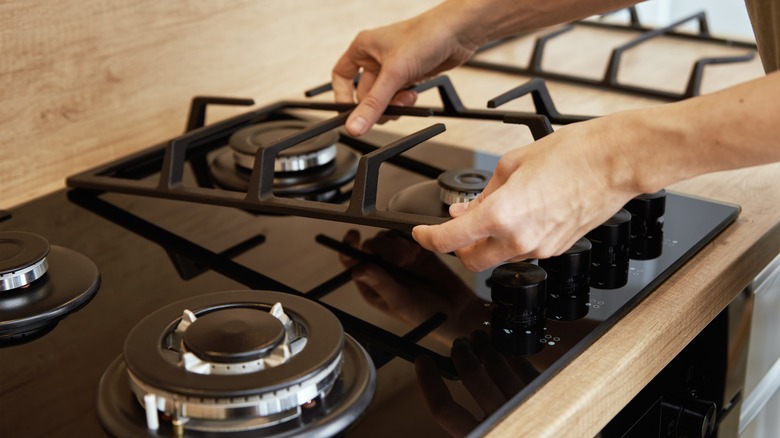 Hands putting gas stove together