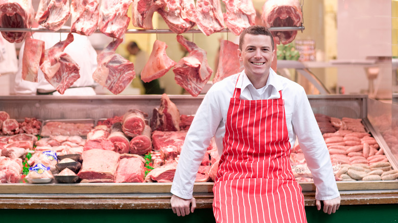 Butcher with cuts of meat