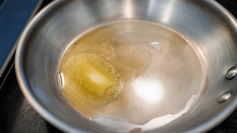 Butter melting in stainless steel skillet