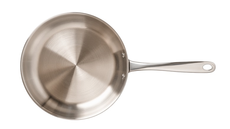 Stainless steel skillet on white background