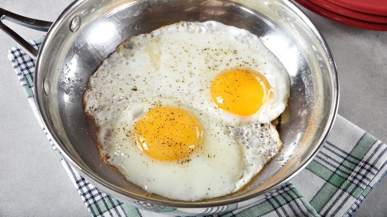 Eggs frying in steel pan