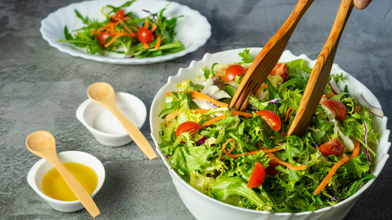 Tongs reaching into salad