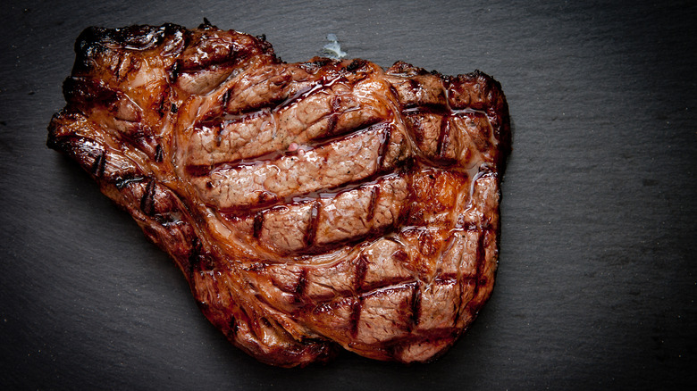 chargrilled steak on black board