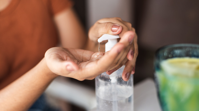 person using hand sanitizer