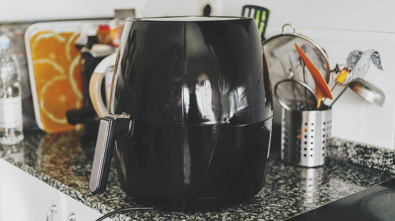 Black air fryer on a kitchen counter