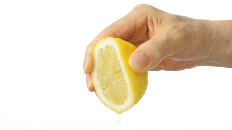 Hand squeezing lemon