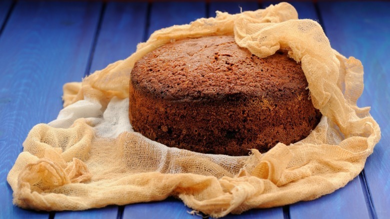 feeding a cake with cheesecloth