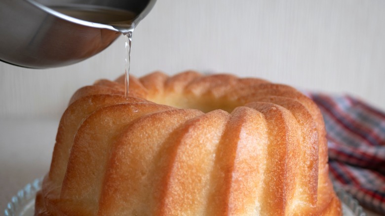 Drizzling simple syrup over cake