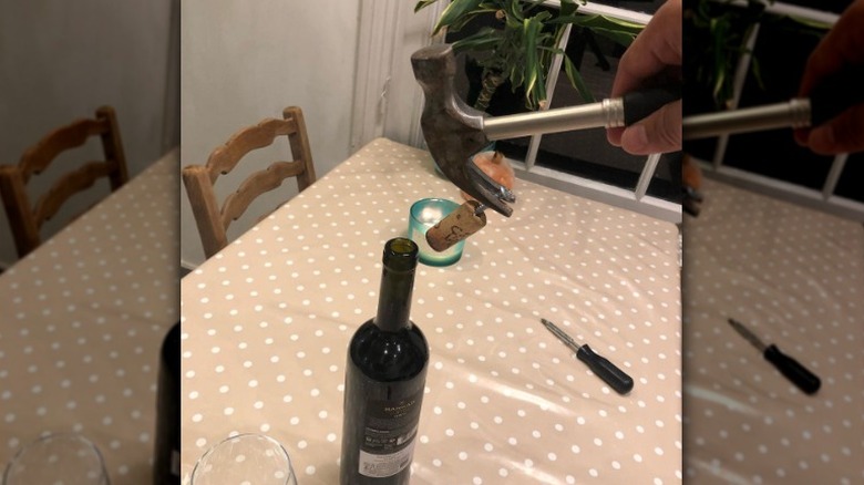 pulling cork out with hammer