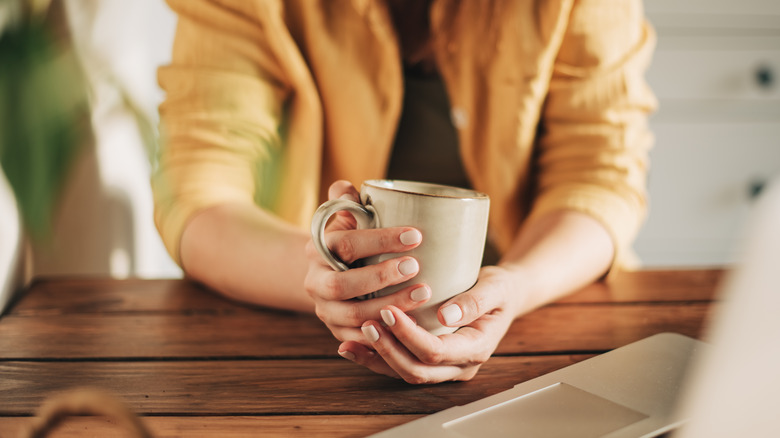 holding warm mug