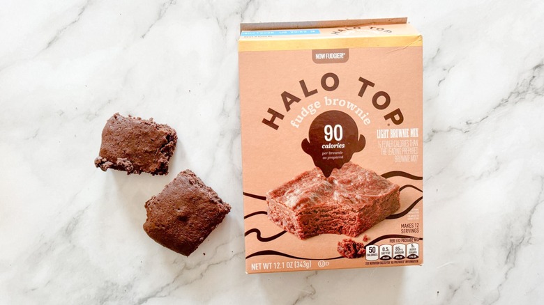 Halo Top fudge brownie and boxed mix on marble background