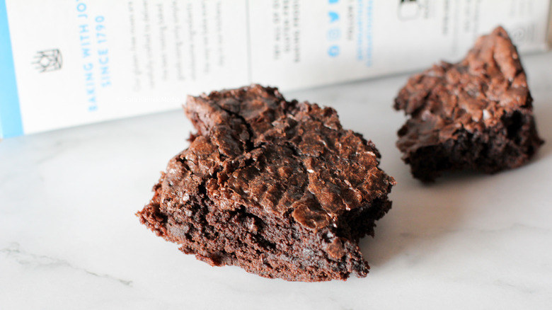 Brownie on marble surface with box in the background