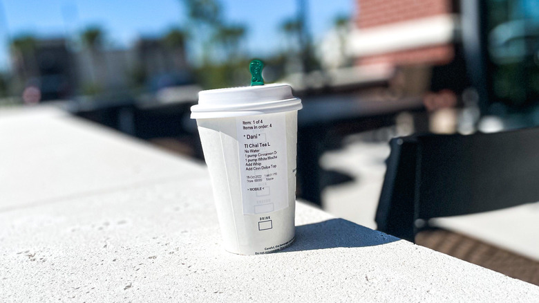 Starbucks cup on outdoor railing