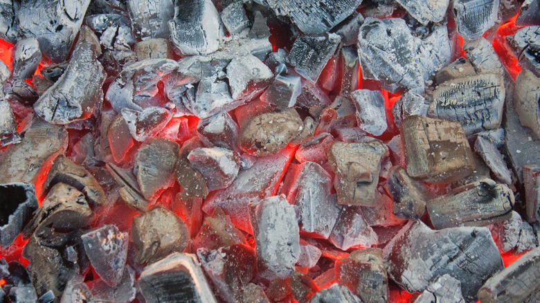 Heating charcoal on grill