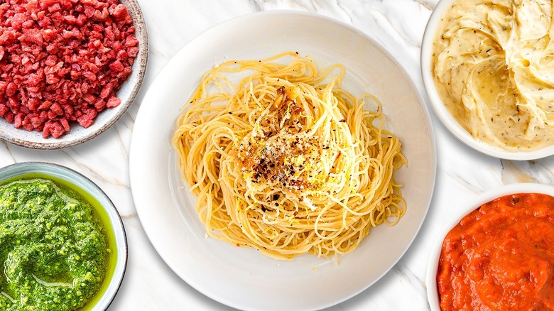 plate of angel hair pasta surrounded by various mix-ins and ingredients