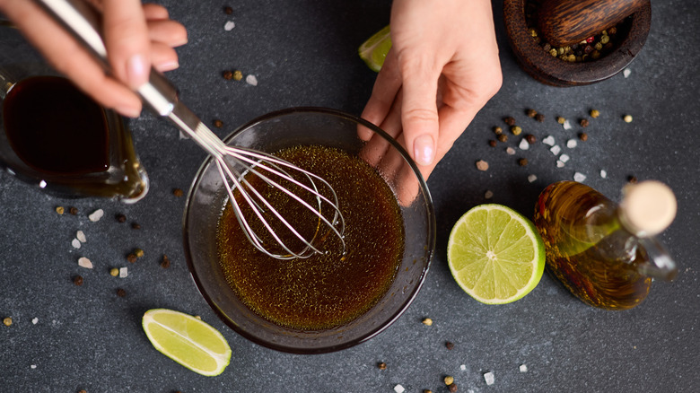 Whisking Asian-inspired sauce in glass bowl