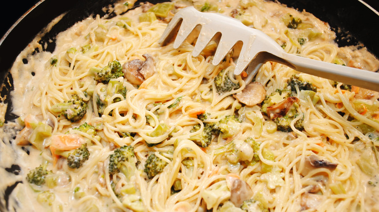 Creamy angel hair pasta with broccoli in pan