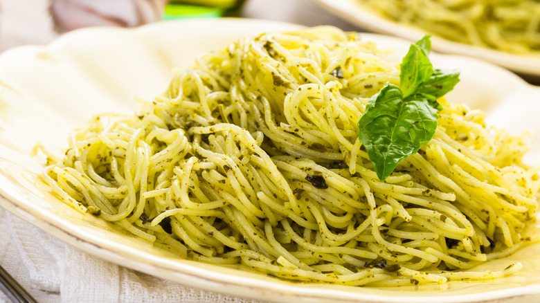 Angel hair pasta with pesto and fresh basil garnish