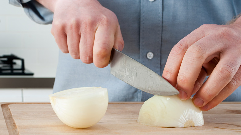 Slicing onion on cutting board