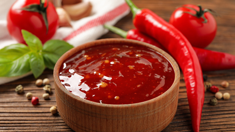 Sweet chili sauce in wooden bowl 