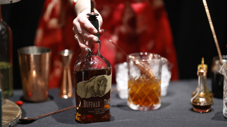 Hand holding Buffalo Trace bottle