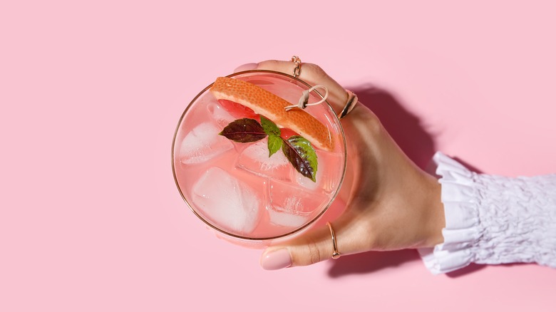 Woman's hand holding a tropical cocktail