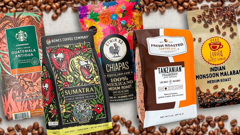 five assorted bags of coffee from different brands with granite background and scattered coffee beans