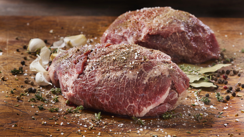 Raw beef cheeks with salt and pepper